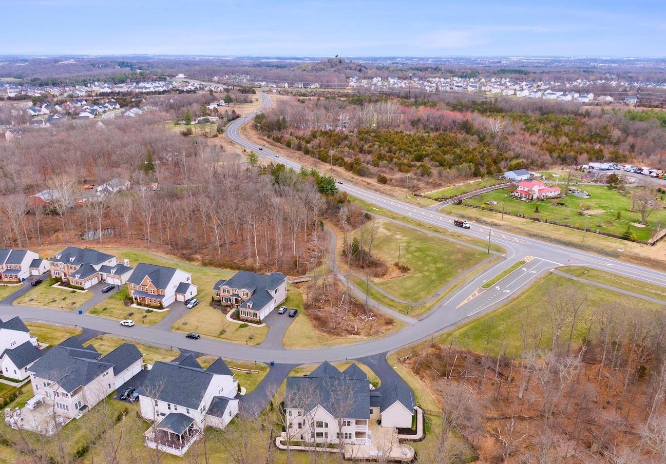 Aerial view of a Northern Virginia residential community with tree lines and roadways