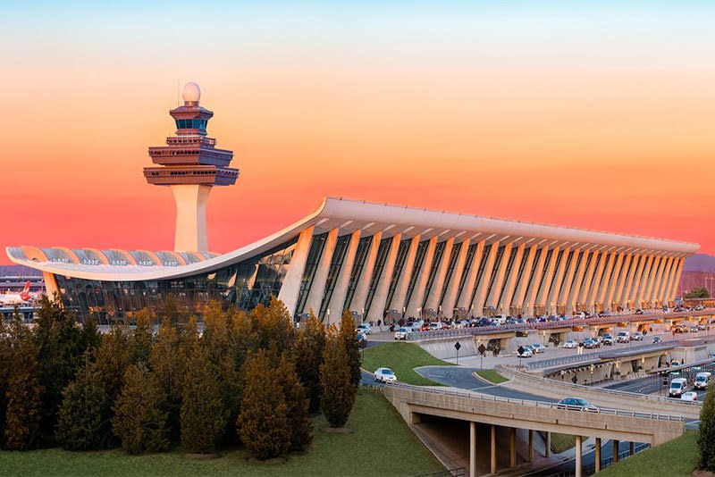 Washington Dulles International Airport terminal and control tower at sunset