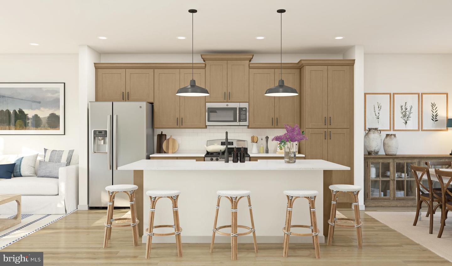 Open-concept kitchen with island seating and light wood cabinetry